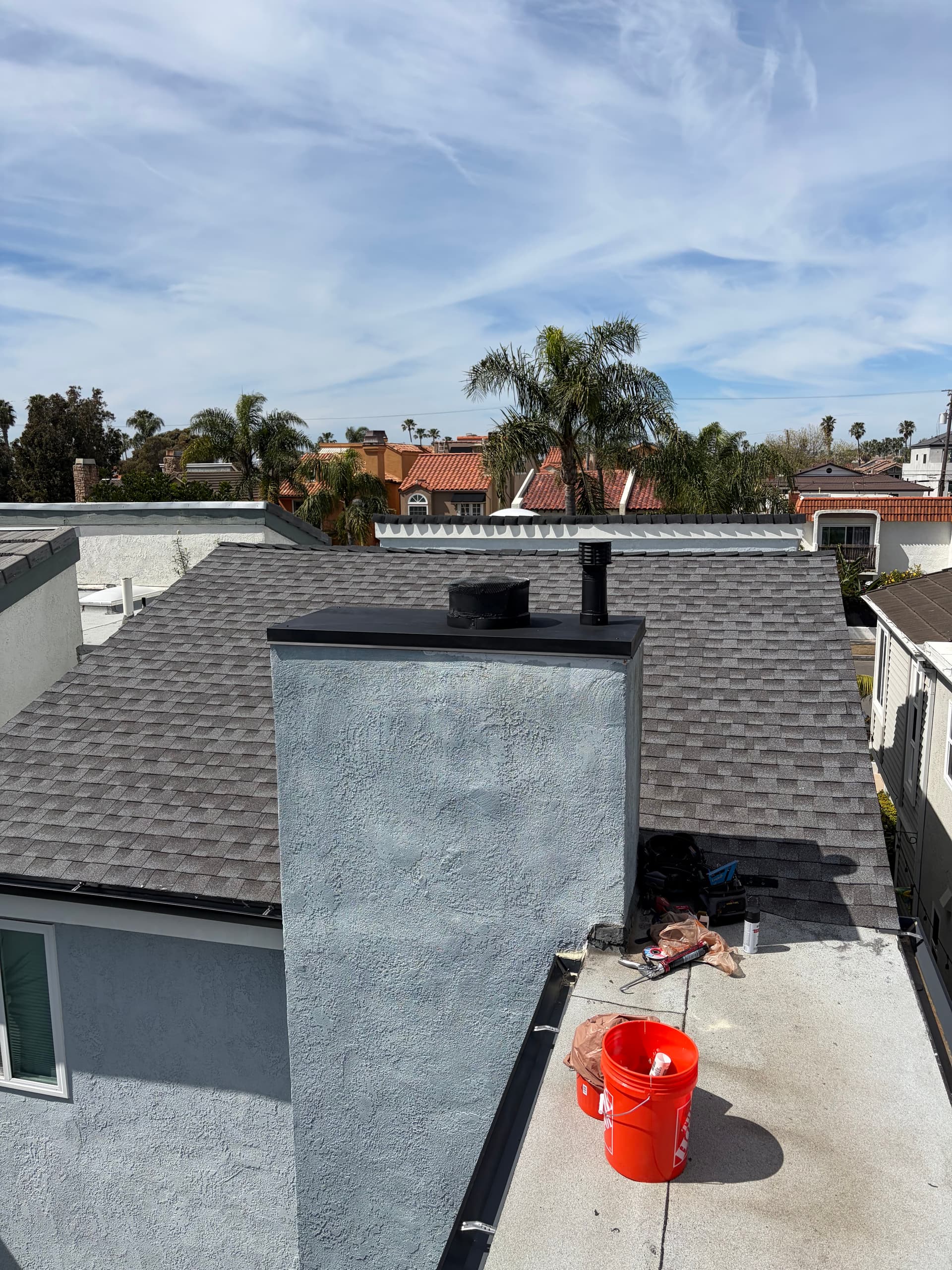 Chimney chase top preparation before shroud installation on a shingle roof