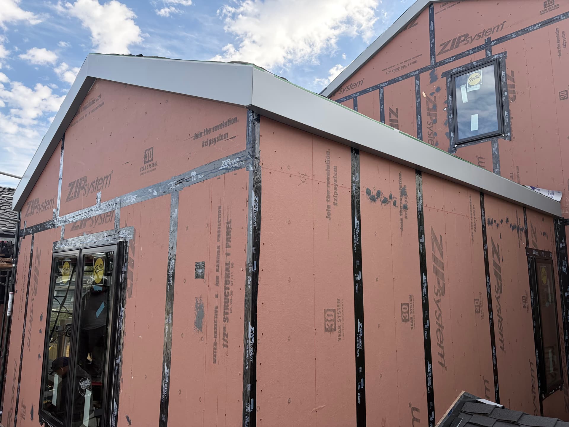 Completed white aluminum fascia wrap on new construction home with ZIP sheathing